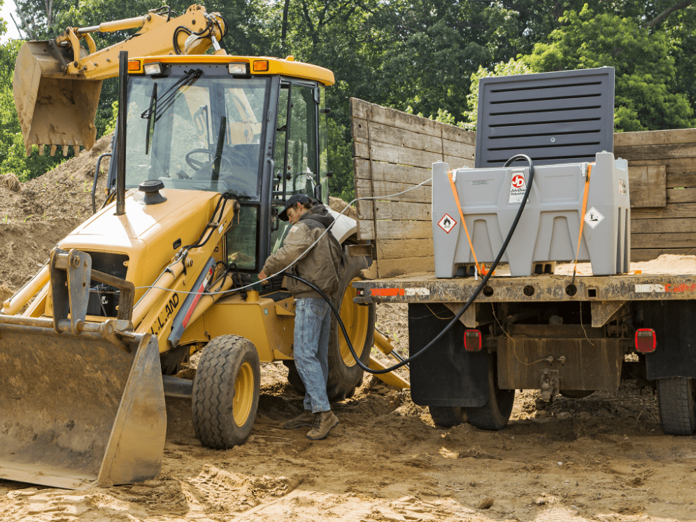 Man Using A Hose To Pump JCB